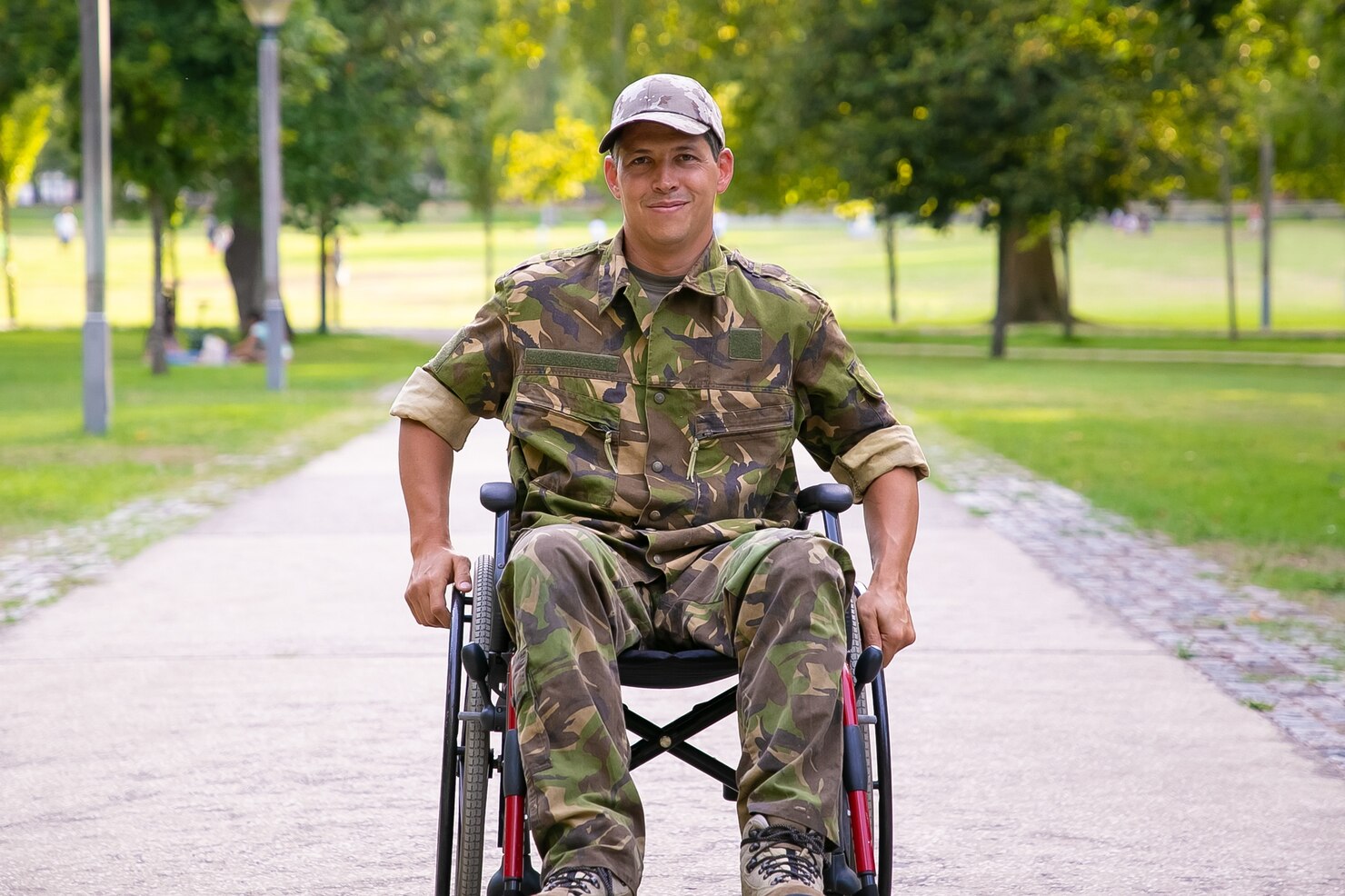 happy-disabled-military-man-wheelchair-wearing-camouflage-uniform-moving-footpath-city-park-front-view-veteran-war-disability-concept_74855-12836.jpg